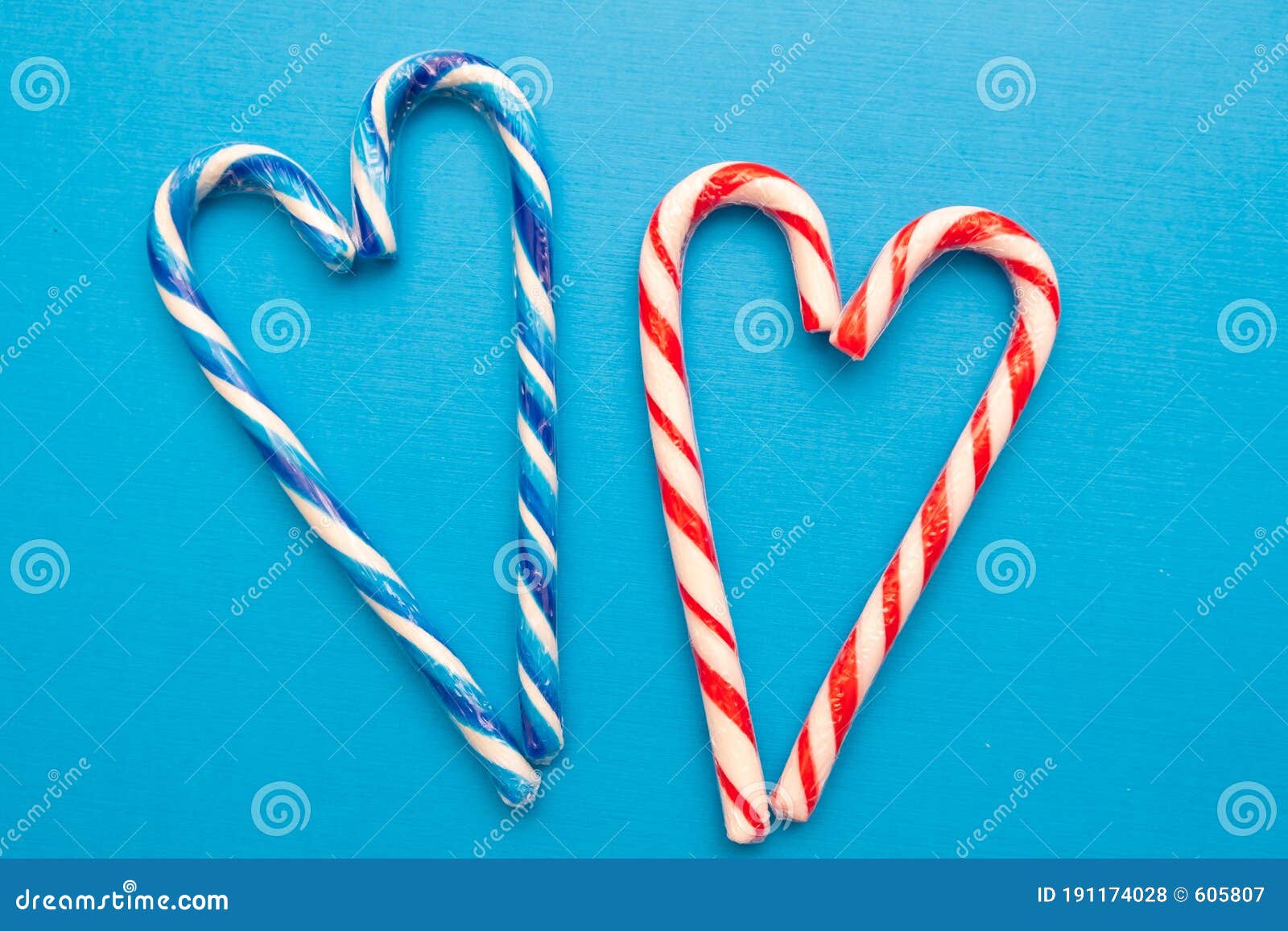 Two Multi-colored Candy Canes in the Form of a Heart on a Blue ...