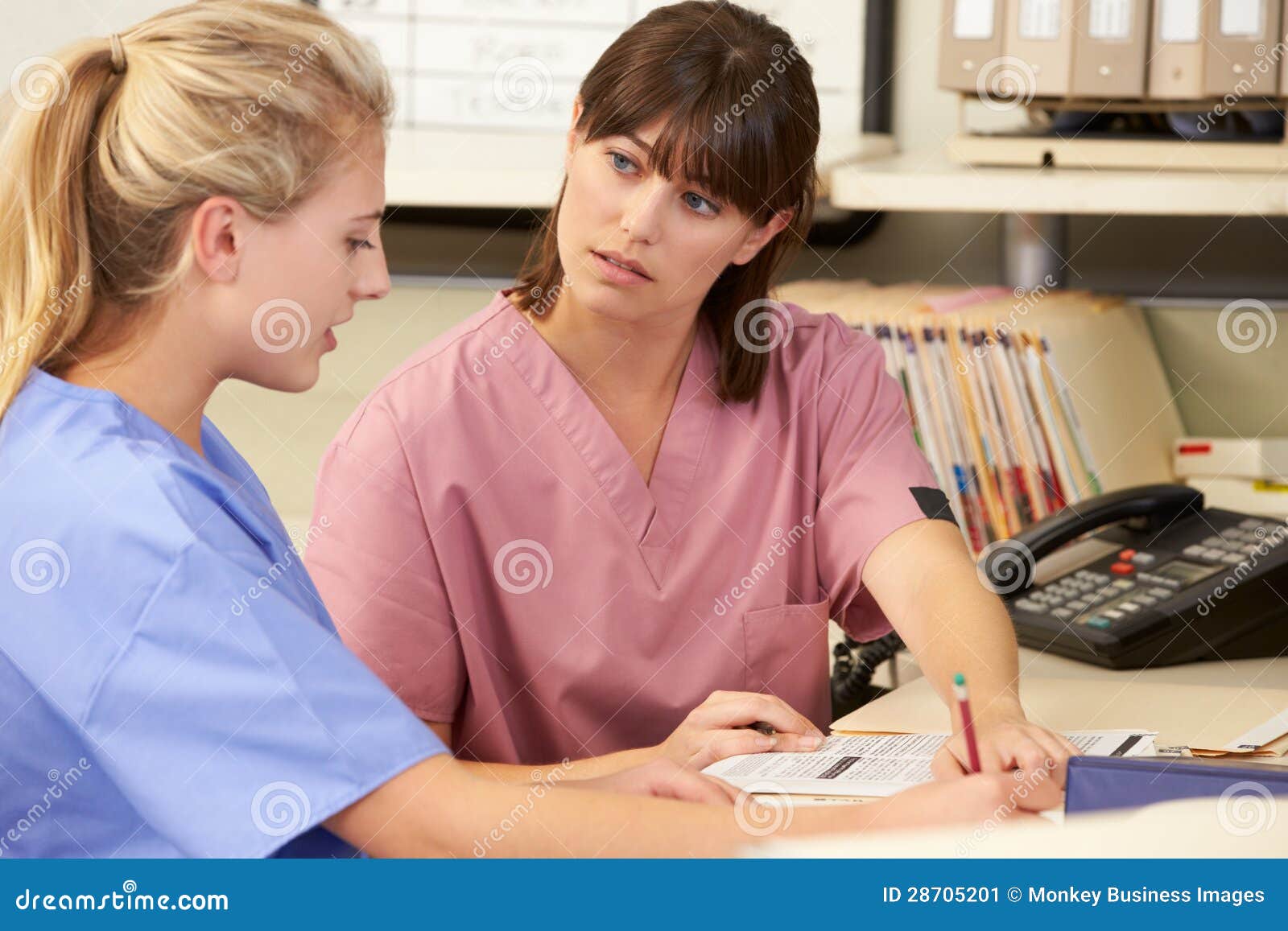 two nurses working nurses station 28705201