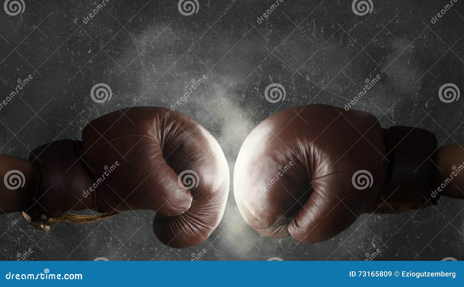 two old brown boxing gloves hit together