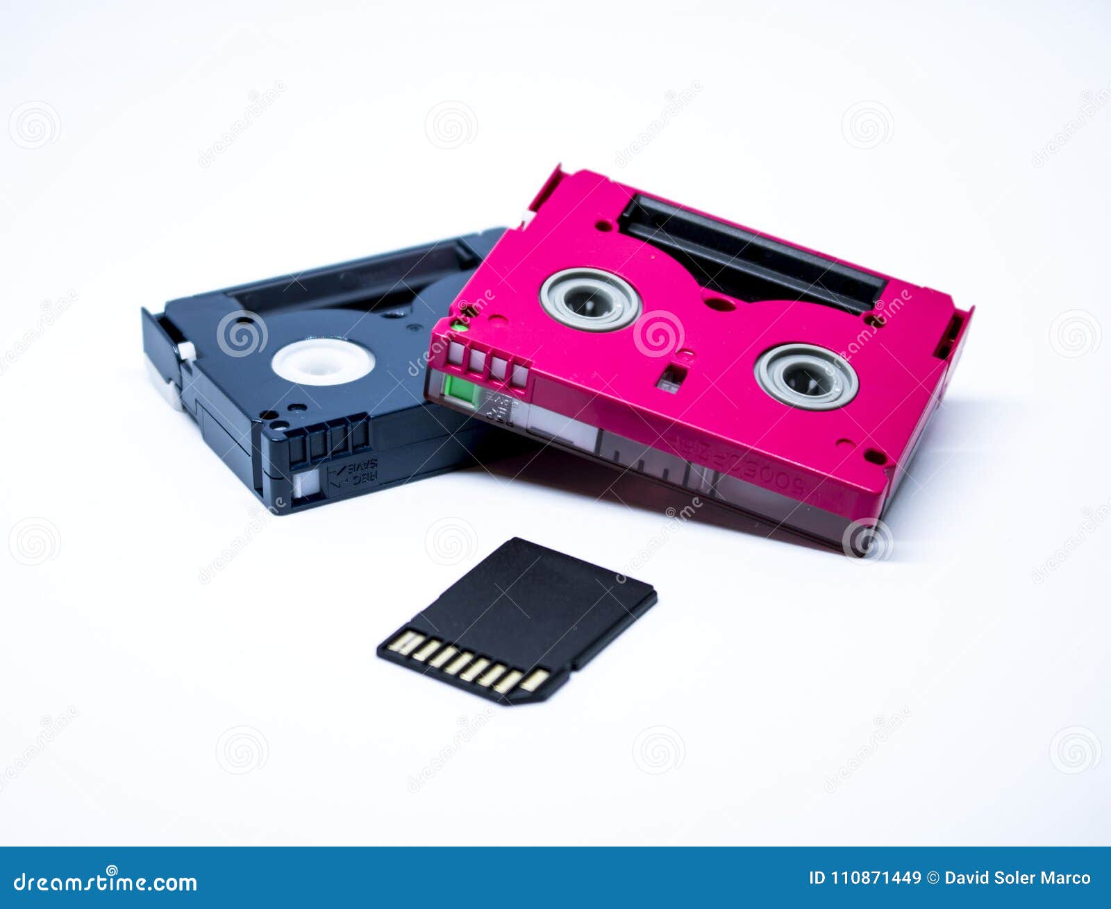 two old cassettes of red and black colors with white background and current sd card