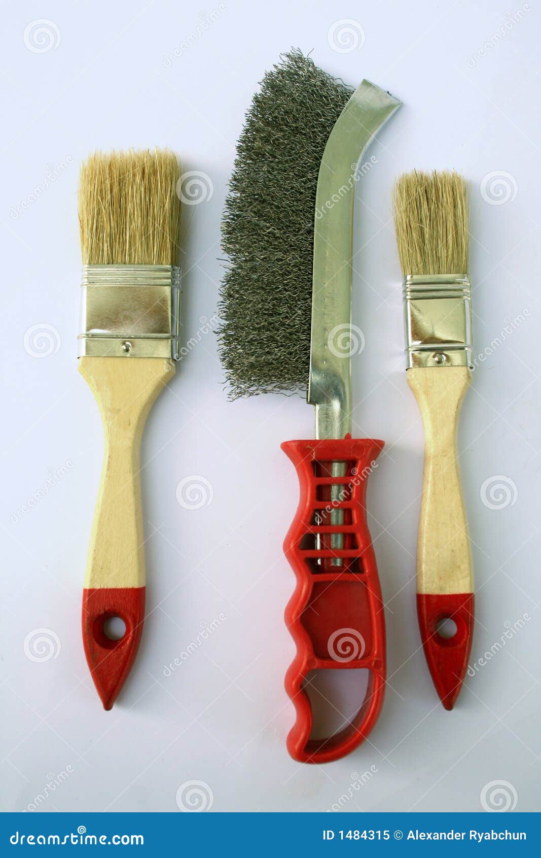 two painting brushes and abrasive brush in the middle