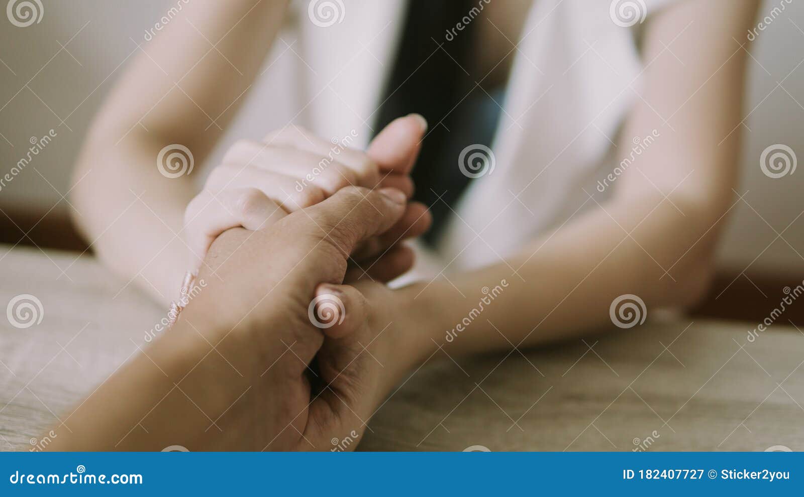 two people holding hands for comfort. giving a helping hand