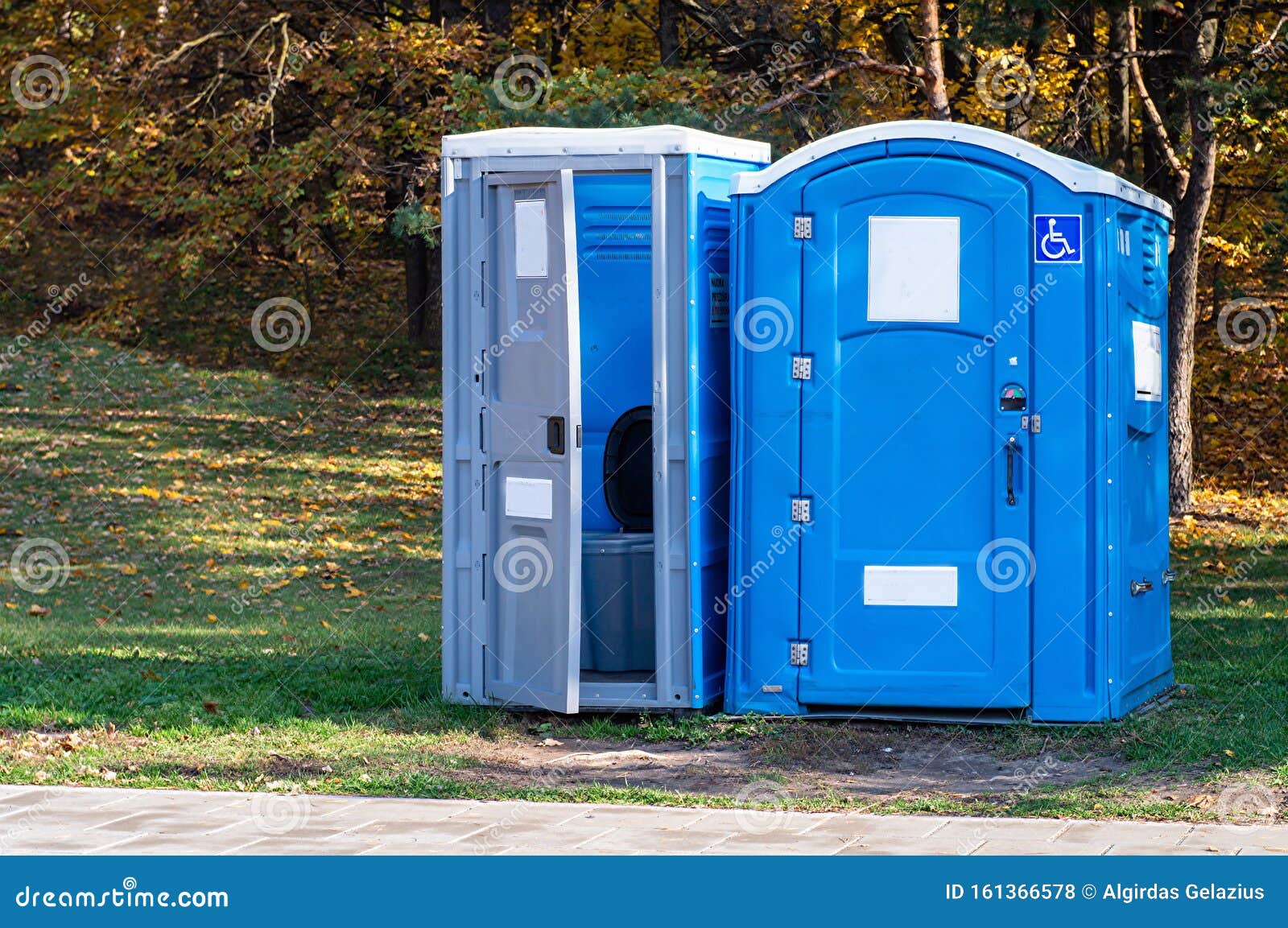 two portable toilets in a park