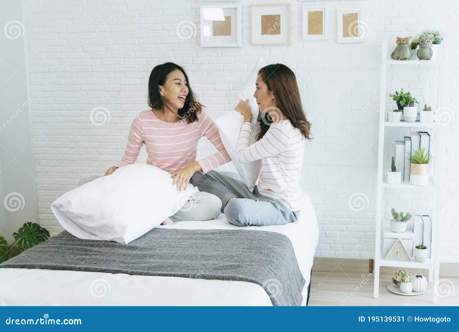 Two Pretty Best Friends Forever Girlfriend Talk Hug And Laugh Together On Bed At Cozy Home