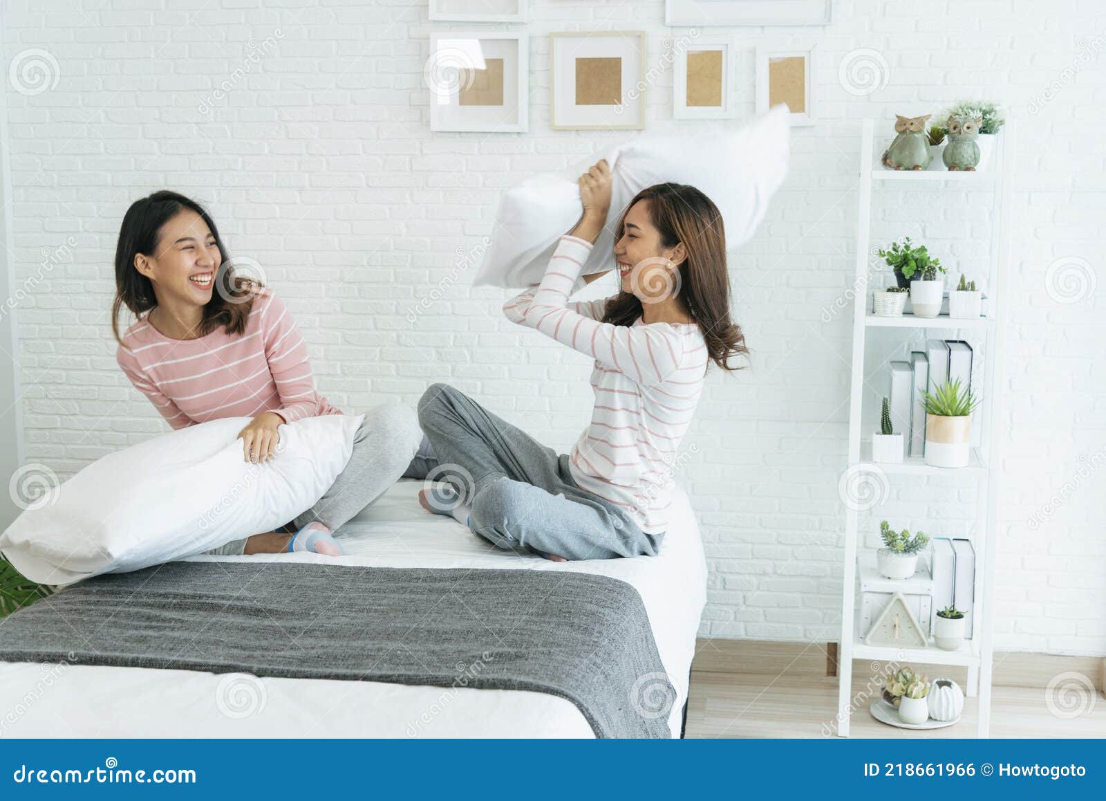 Two Pretty Best Friends Forever Girlfriend Talk Hug And Laugh Together On Bed At Cozy Home