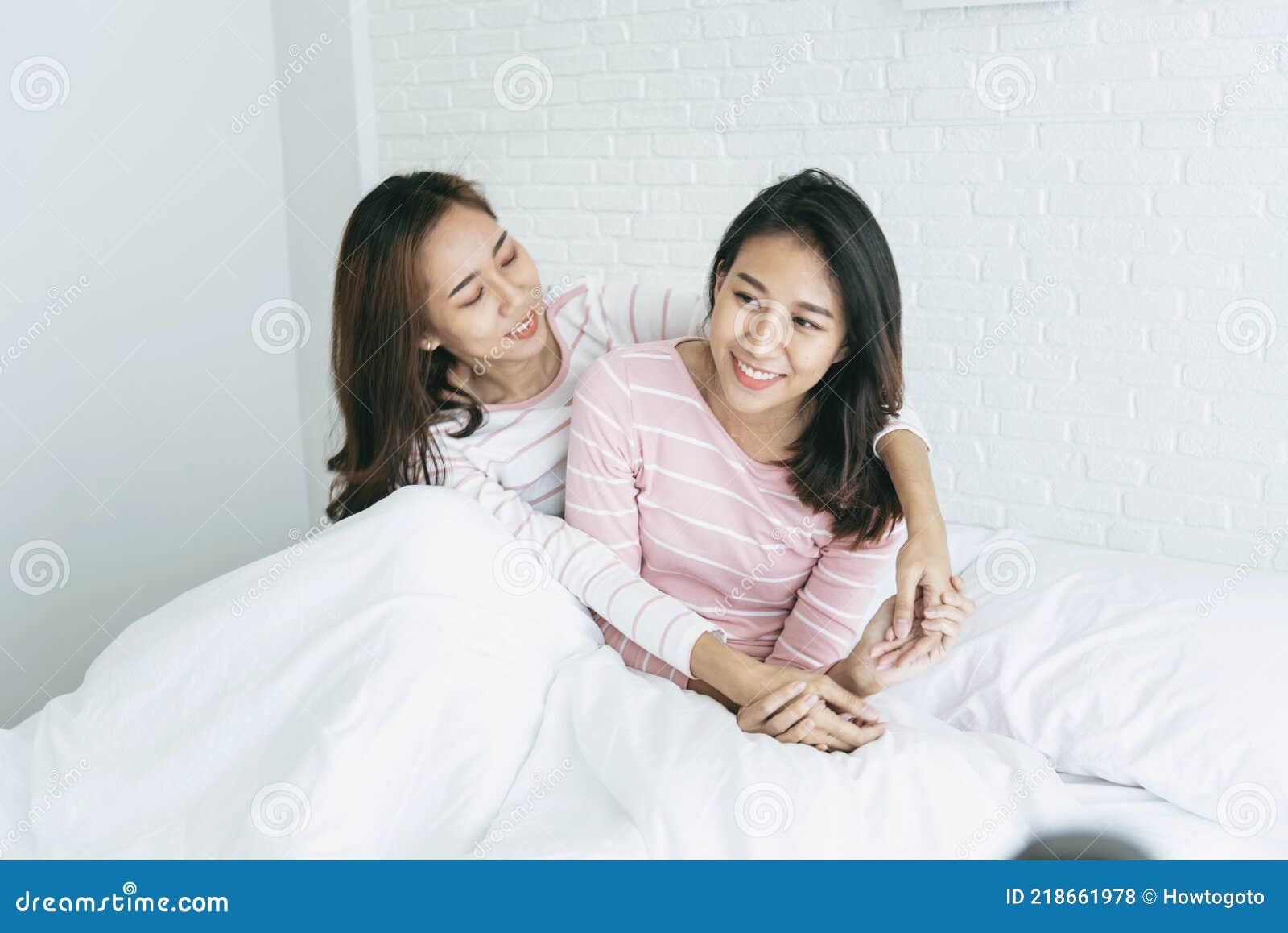 Two Pretty Best Friends Forever Girlfriend Talk Hug And Laugh Together On Bed At Cozy Home