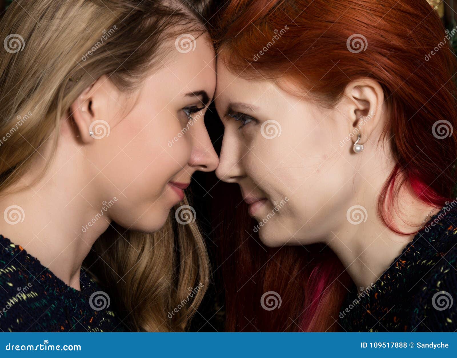 Two Pretty Lesbians Girlfriends Kissing And Hugging In A Cozy