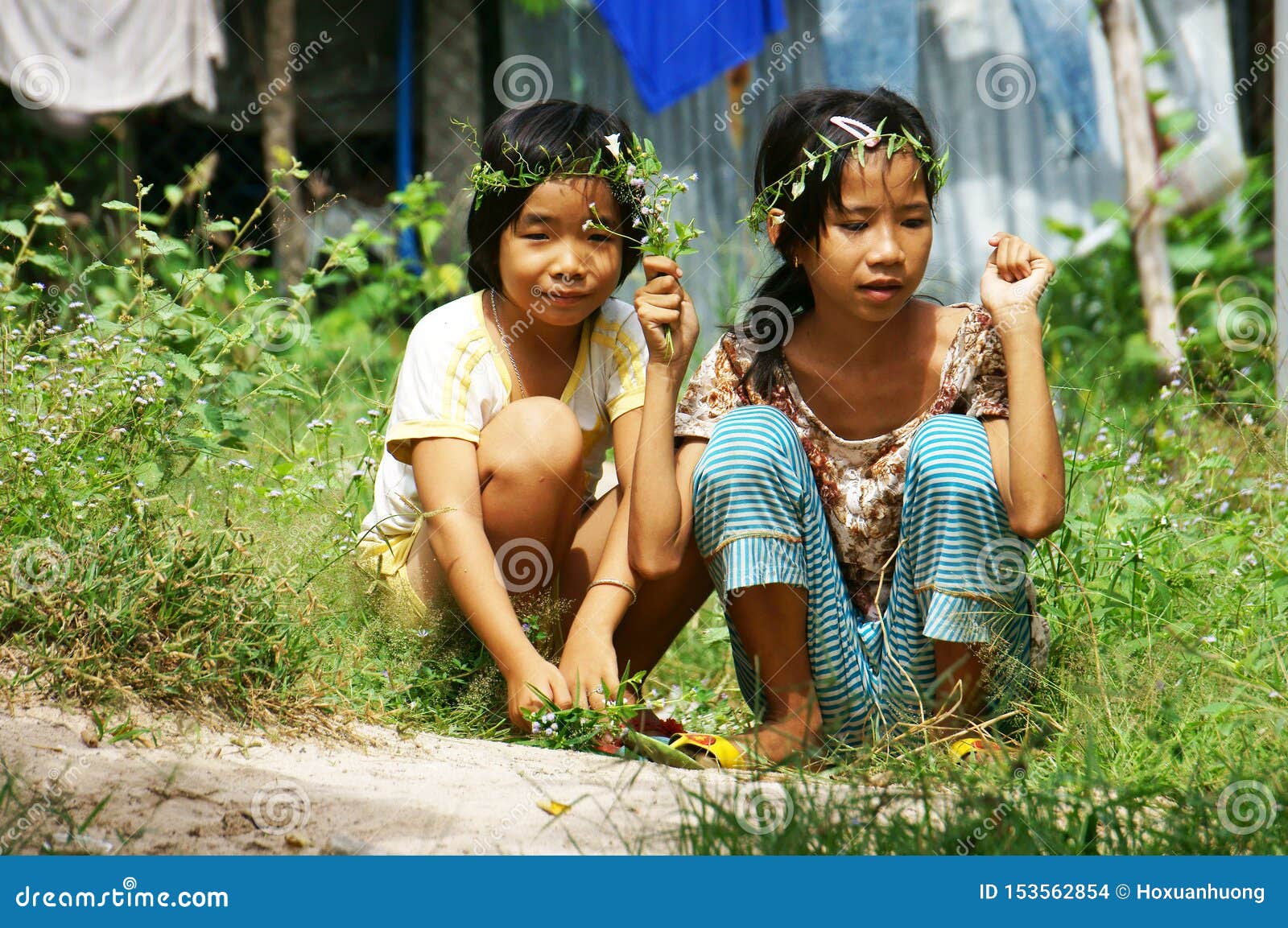 Two Pretty Little Girls Picking Wild Flower To Make Head Wreath at ...