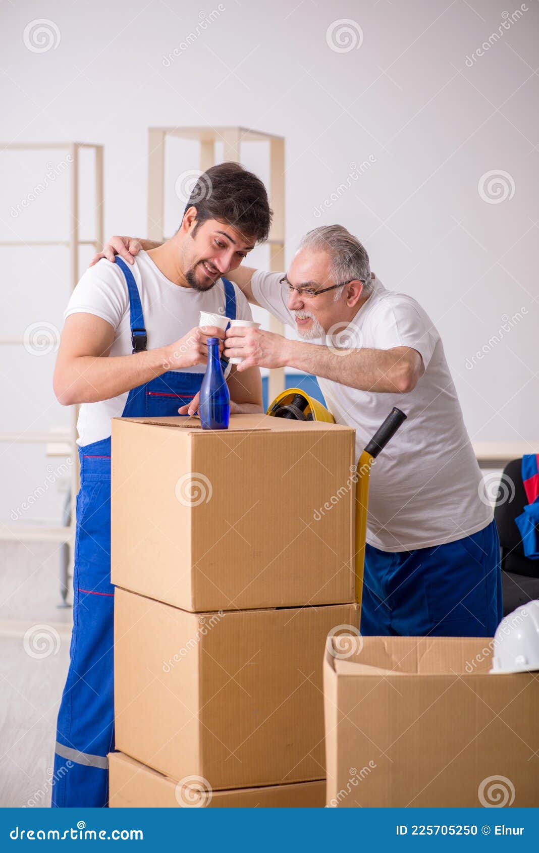 Two Male Professional Movers Drinking Alcohol during Break Stock Photo
