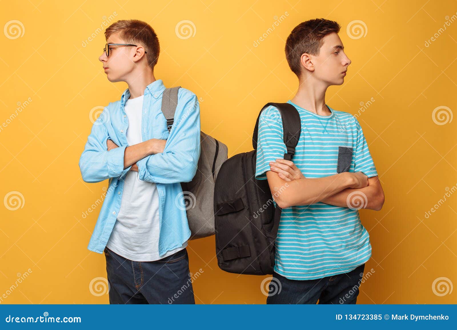 two proud teenage boys, offended at each other and unwilling to admit their guilt, are  against a yellow background