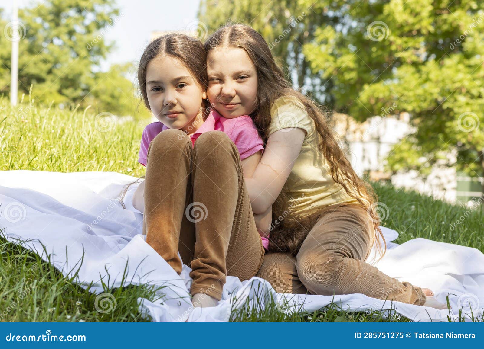 Two Real Little Girls, Sisters Hugging on Grass in Meadow at Sunny Day ...