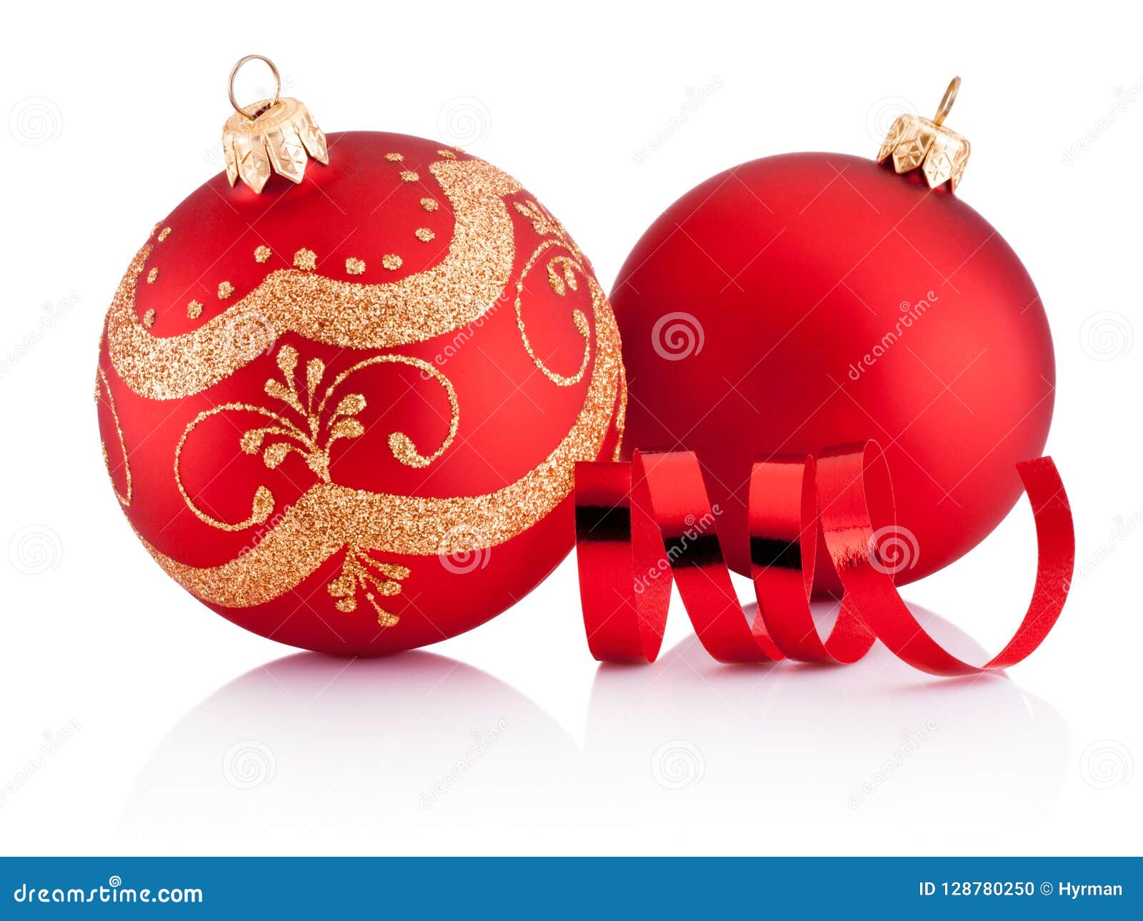 two red christmas decoration baubles and curling paper 