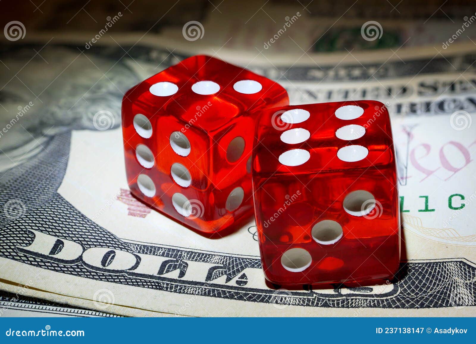Two Red Dice on Dollar Banknote Under Spot of Hard Light Stock Image