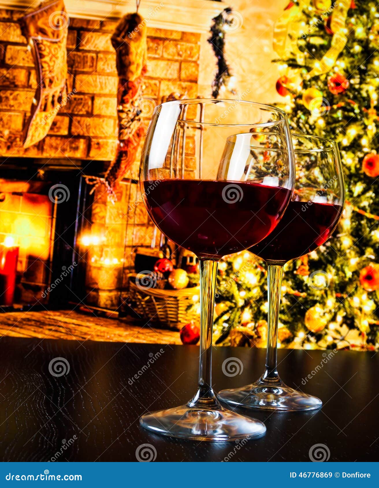 Two Red Wine Glasses Against Christmas Tree Background Stock Image