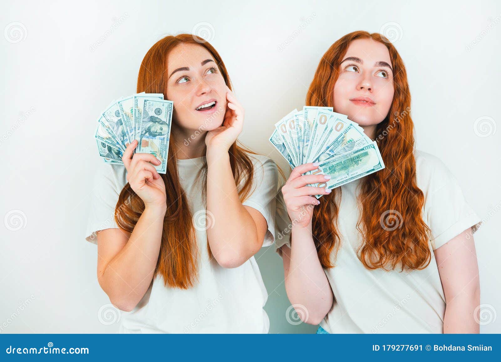 Two Redheaded Young Women Both Holding Cash Like Playing Cards Looking ...