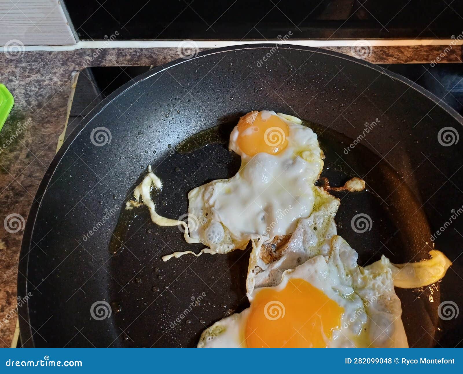 two rganic free range eggs cooked sunny side up in a non-stick high quality pan
