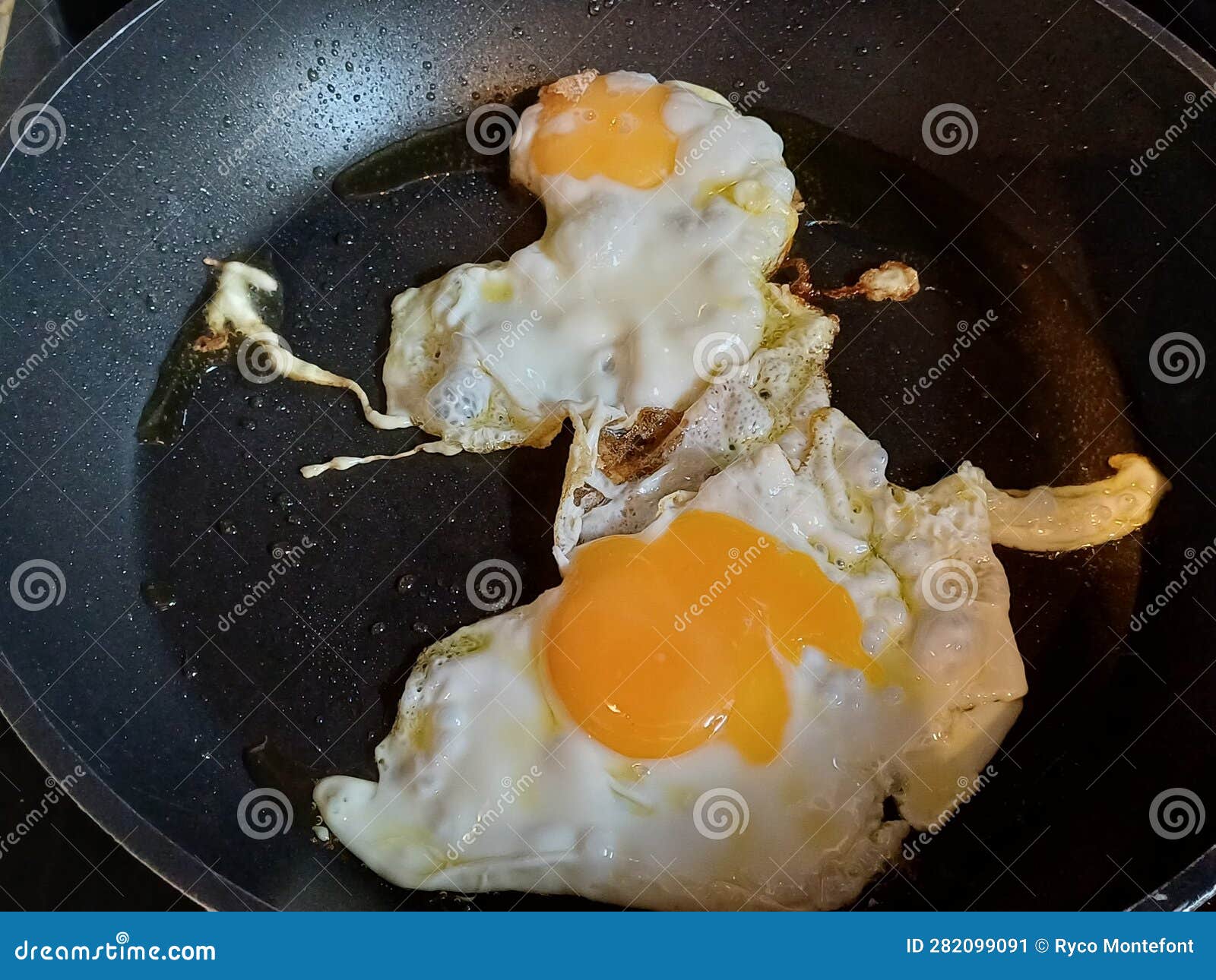 two rganic free range eggs cooked sunny side up in a non-stick high quality pan