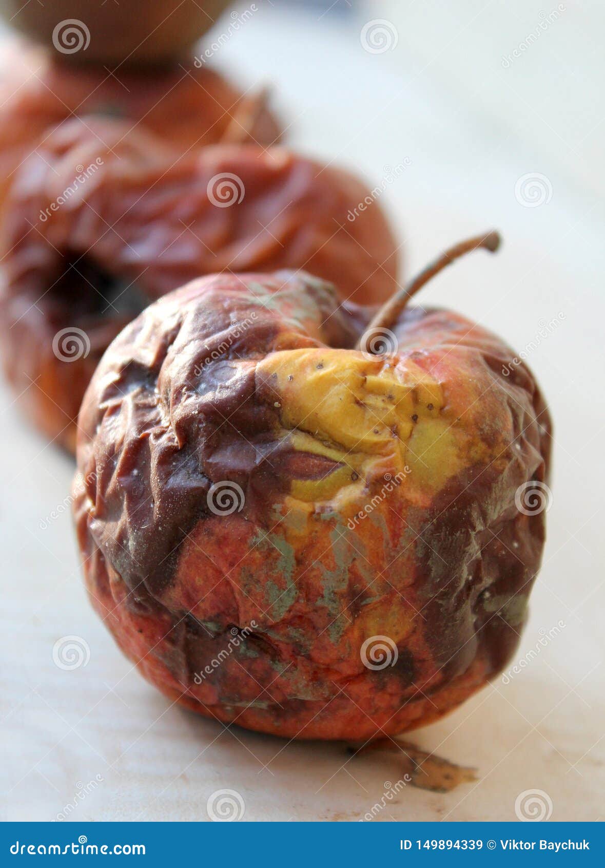 Two rotten apples in a row stock image. Image of 149894339