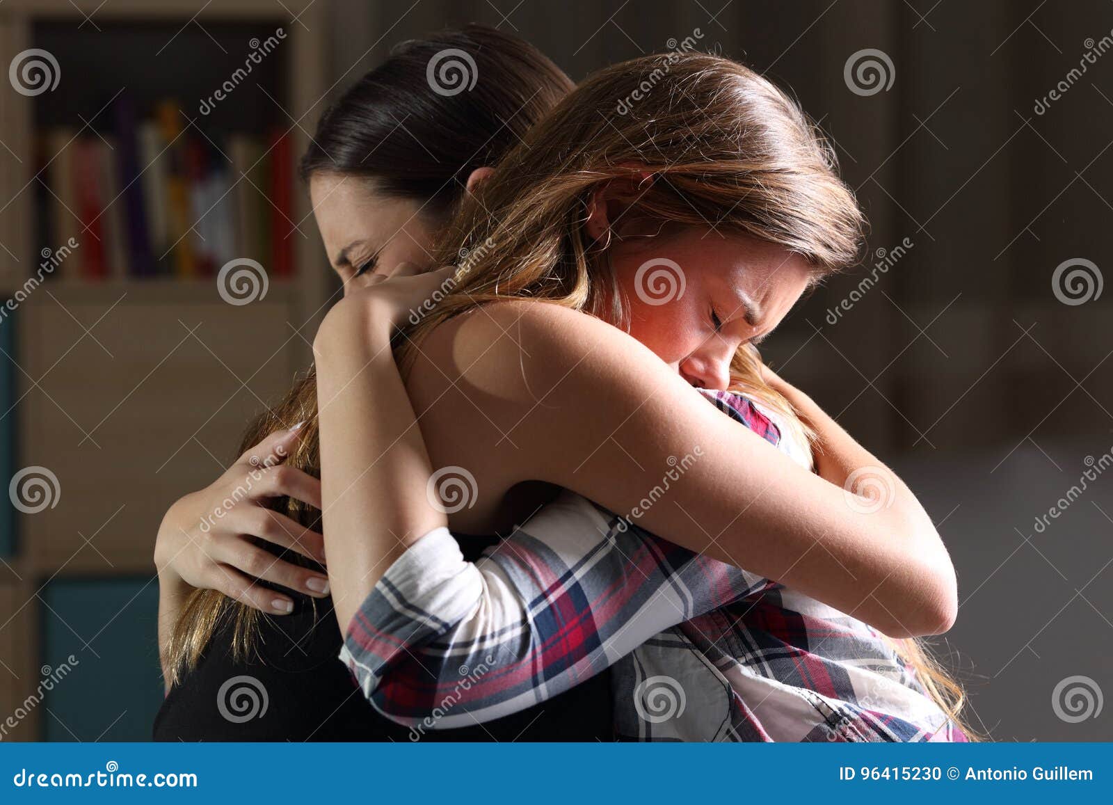two sad teens embracing at bedroom