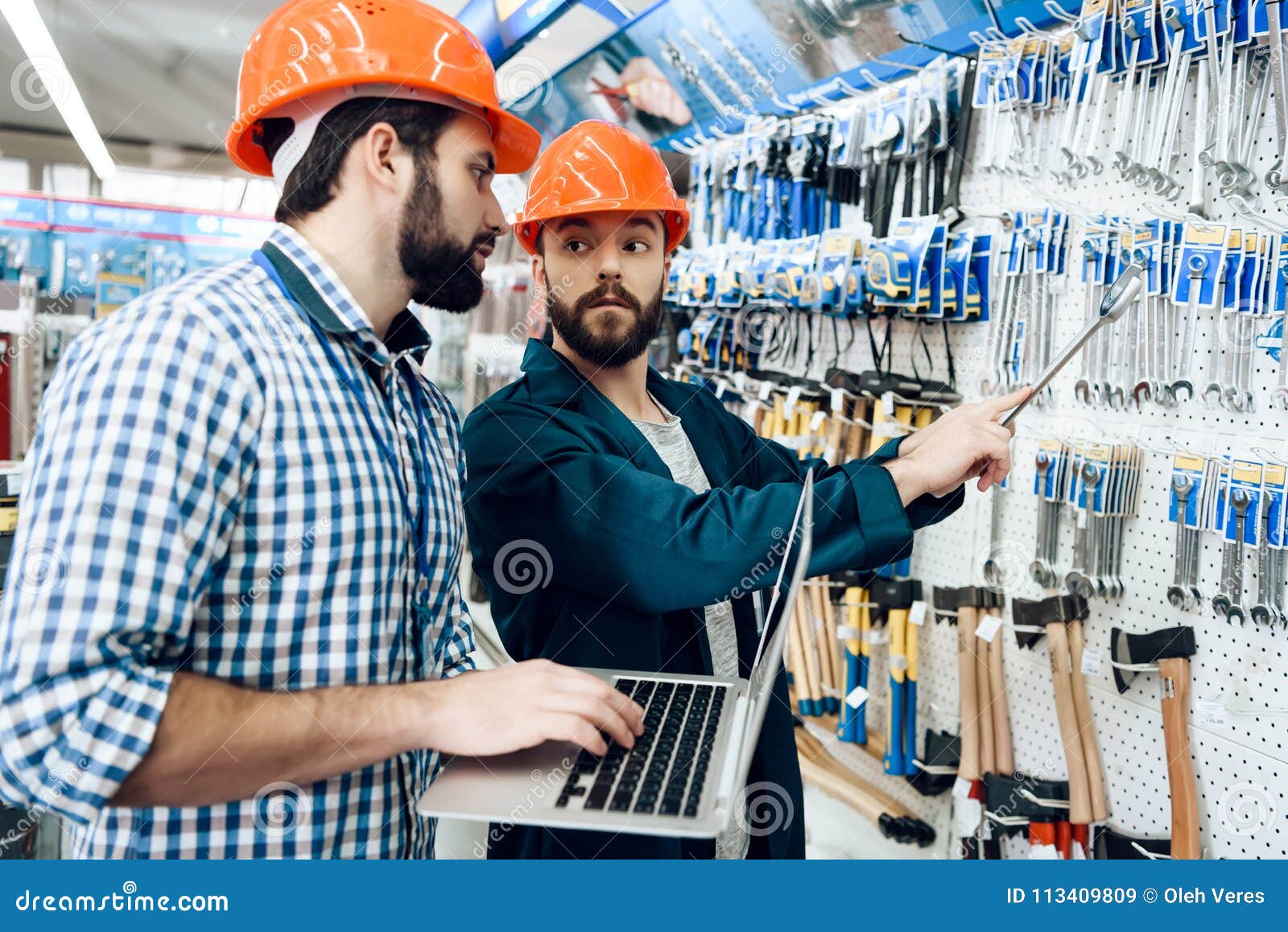 Two Salesmen are Checking Equipment Selection in Power Tools Store