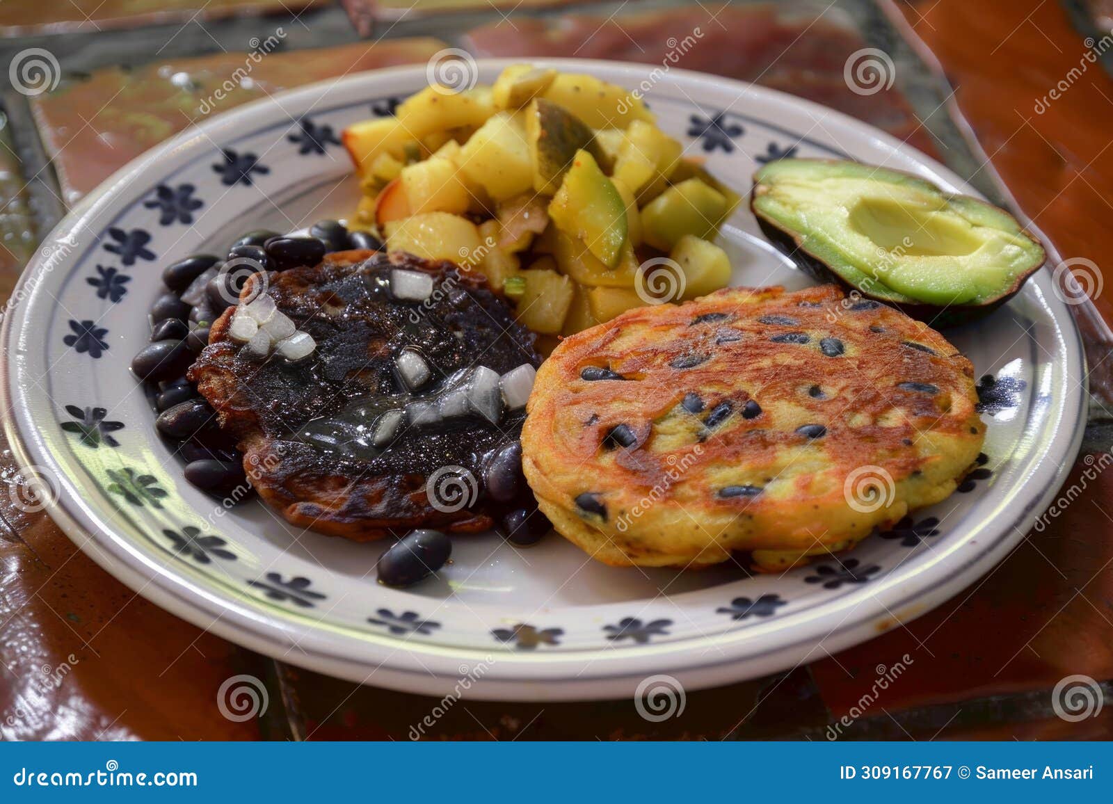 two savory black bean and potato pancakes served on a plate with angua a la cocina, mexican food background image