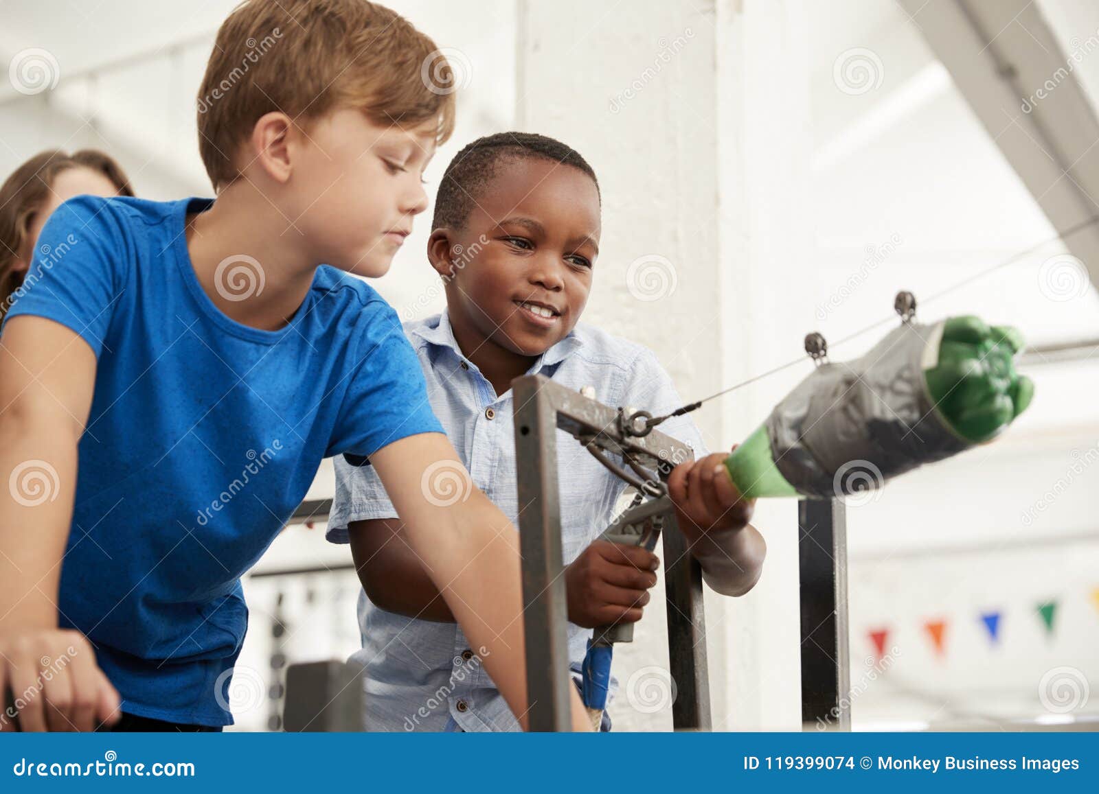 two schoolboys using air pressure rocket at a science centre