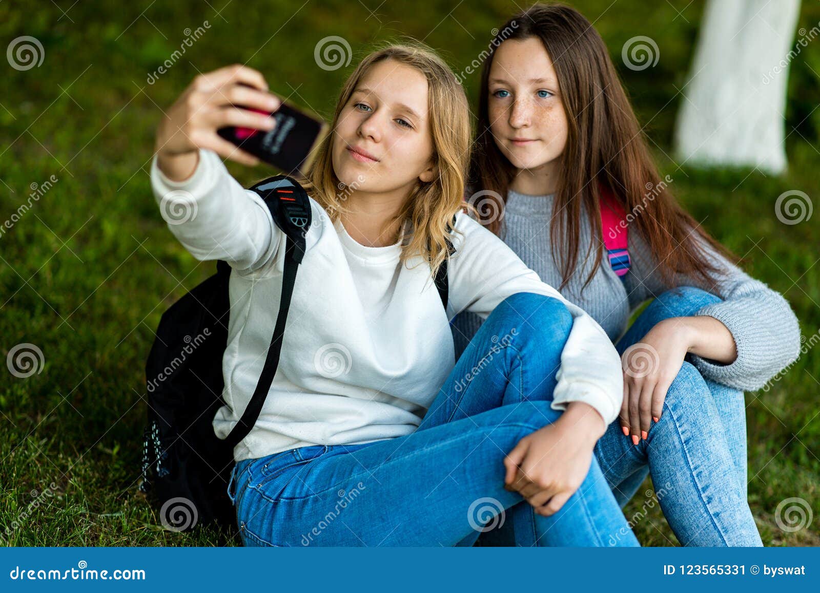 Two Schoolgirls Teenage Girl Sitting on Grass in Summer in Park. in His ...