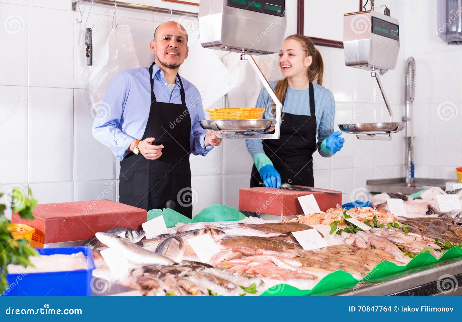 Two sellers in fish store stock photo. Image of adults 70847764
