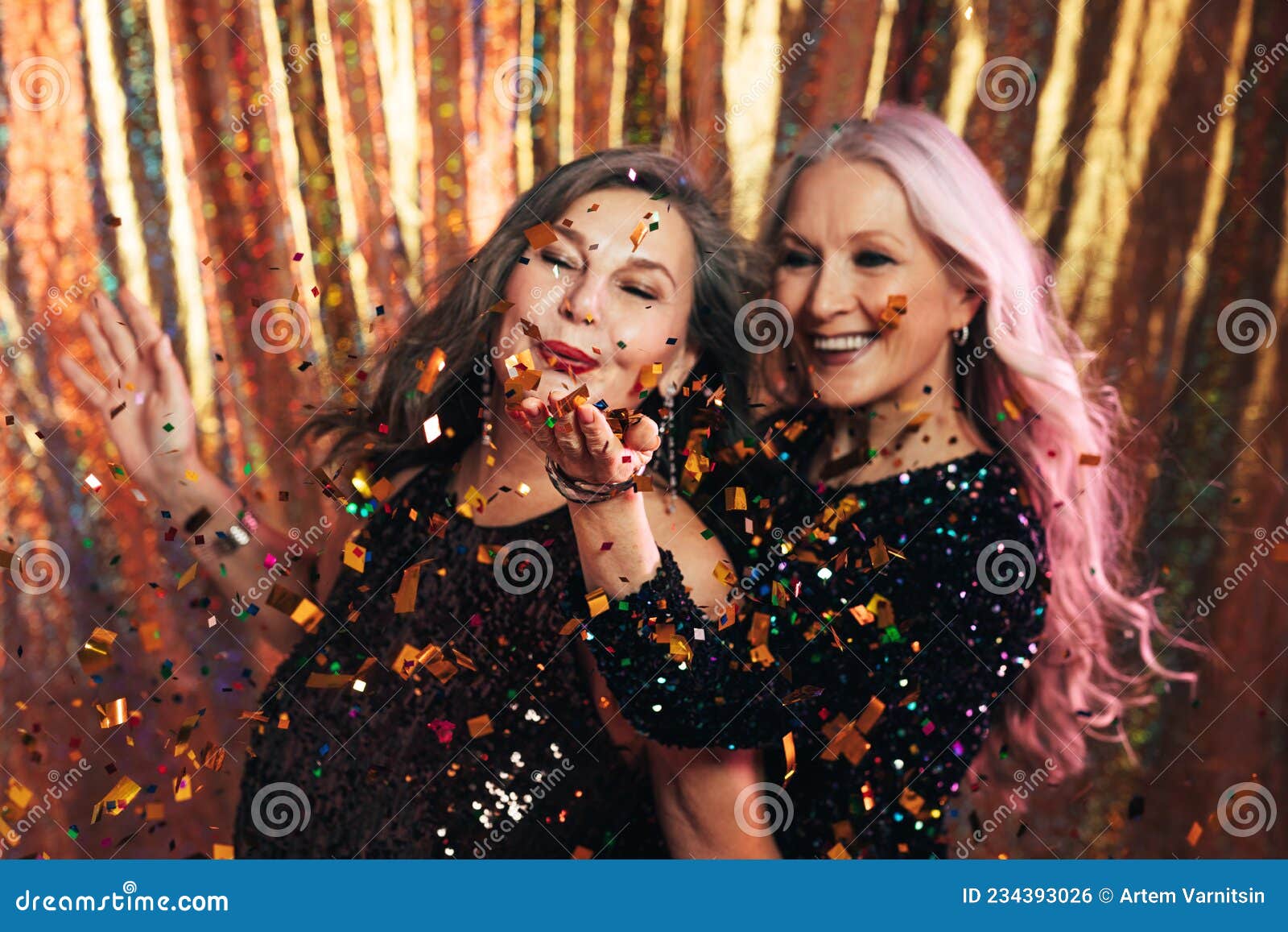 Two Senior Girlfriends Having Fun in Studio Blowing Confetti Stock ...