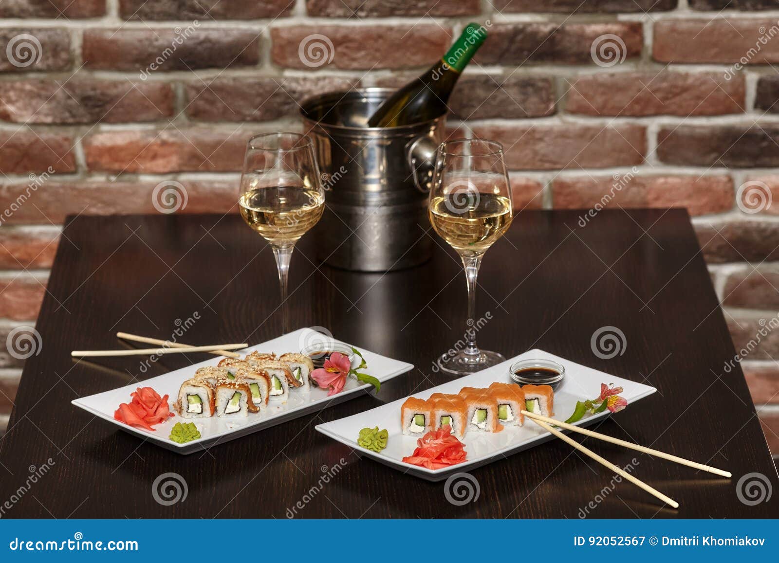 Two Sets of Sushi Rolls with Chopsticks and Wine Glasses Stock Image