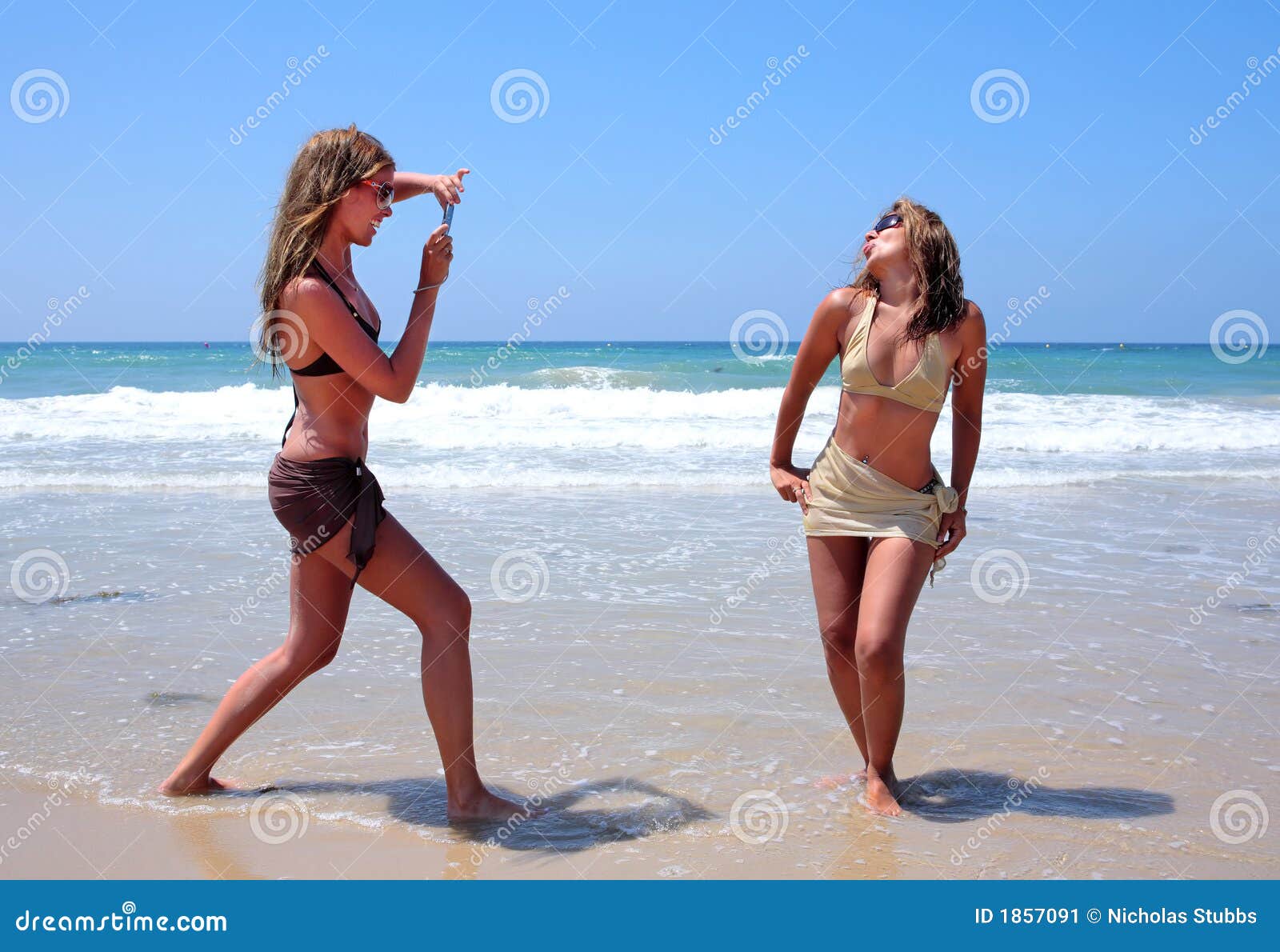 Two Young Women Playing on the Beach on Vacation or Holiday Stock Image