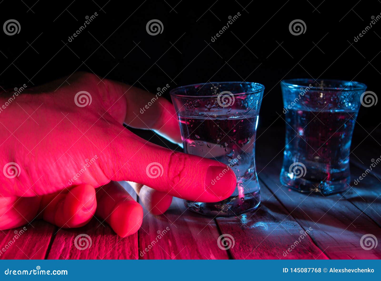 Two Shots of Vodka in the Multiple Bar Lights, Closeup Stock Photo