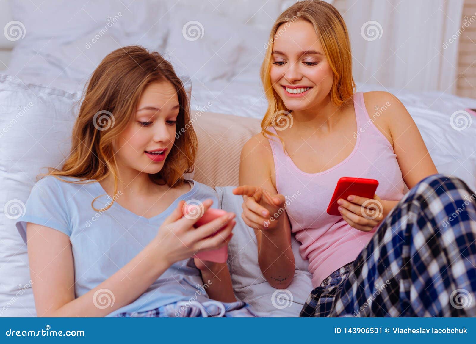 Two Siblings Shopping Online in the Bedroom Together Stock Image ...