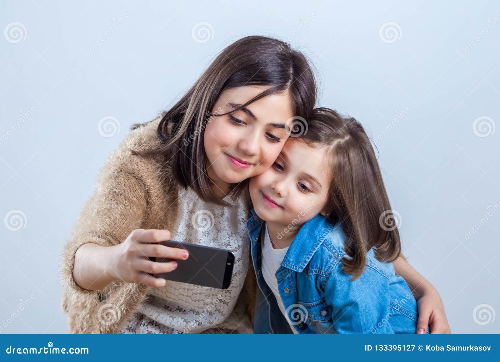 Two Sisters of Different Ages Take a Selfie in a Photo Studio Stock ...