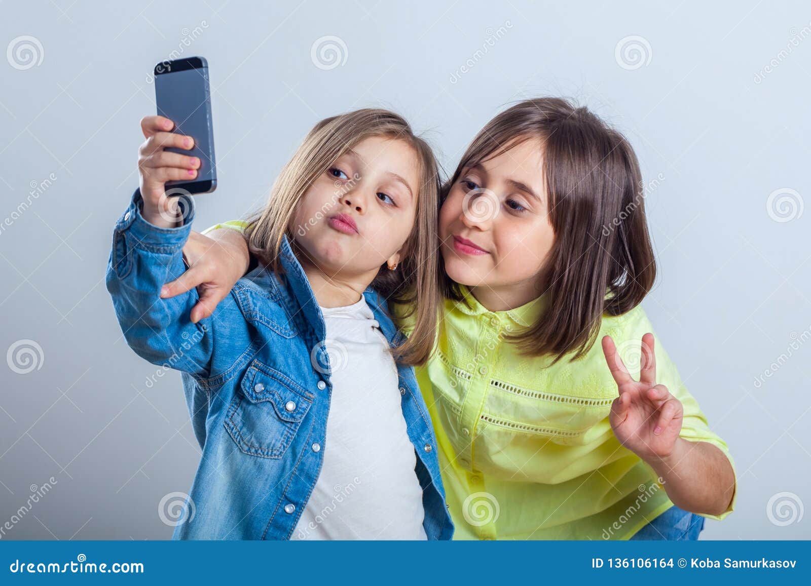 Two Sisters Posing and Taking Selfies in the Studio Stock Photo - Image ...