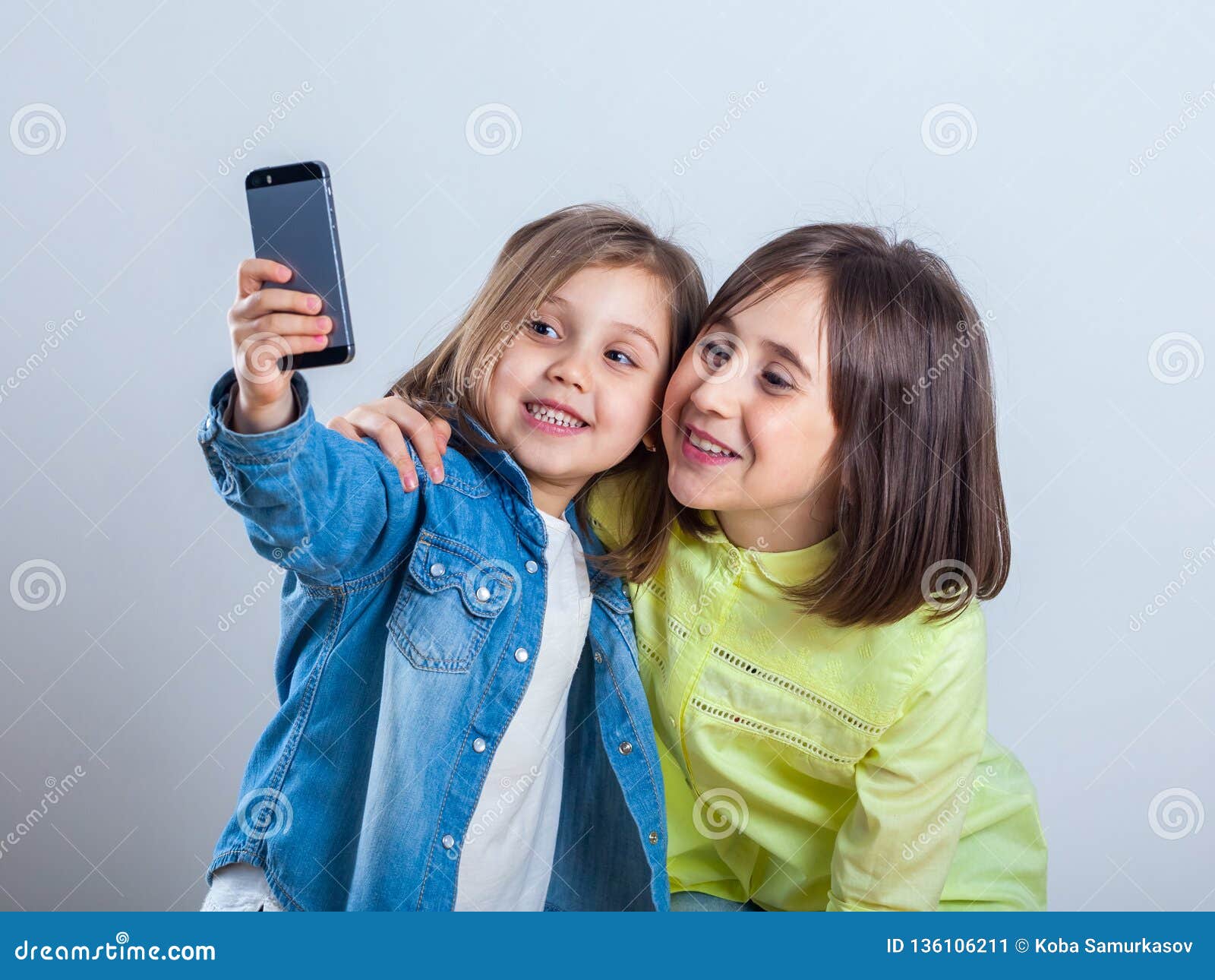 Two Sisters Posing and Taking Selfies in the Studio Stock Image - Image ...