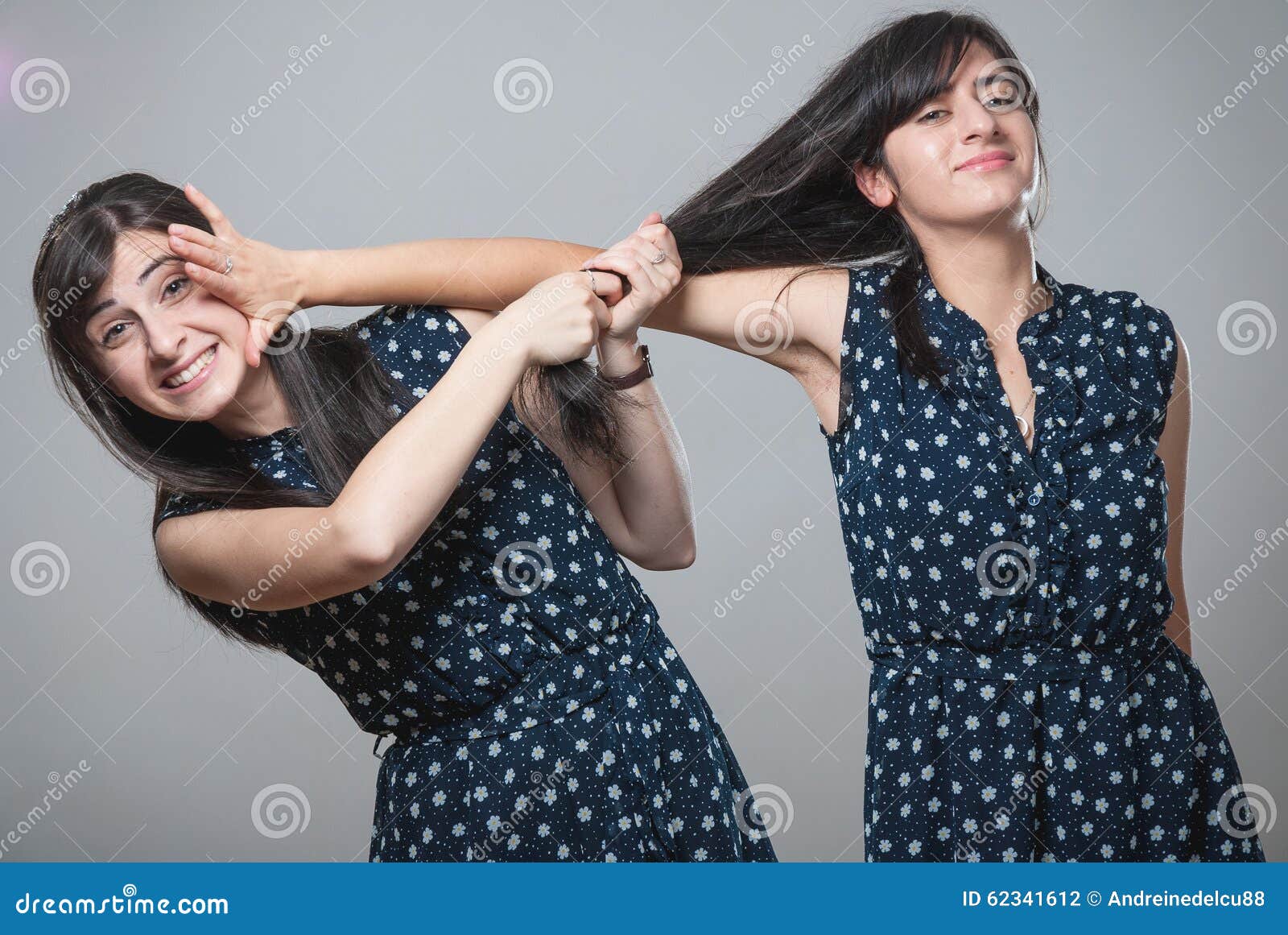 Two sisters pulling hair stock photo. Image of arguing - 62341612