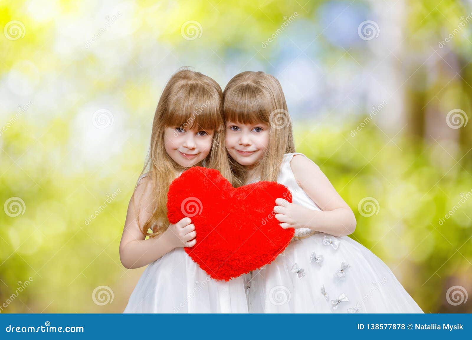 Two Sisters Twins are Holding Red Heart Together Stock Photo ...