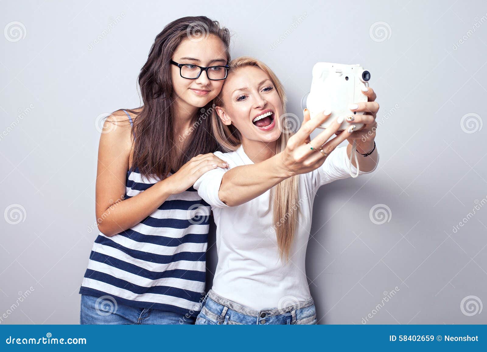 Two sisters using camera. stock image. Image of light - 58402659