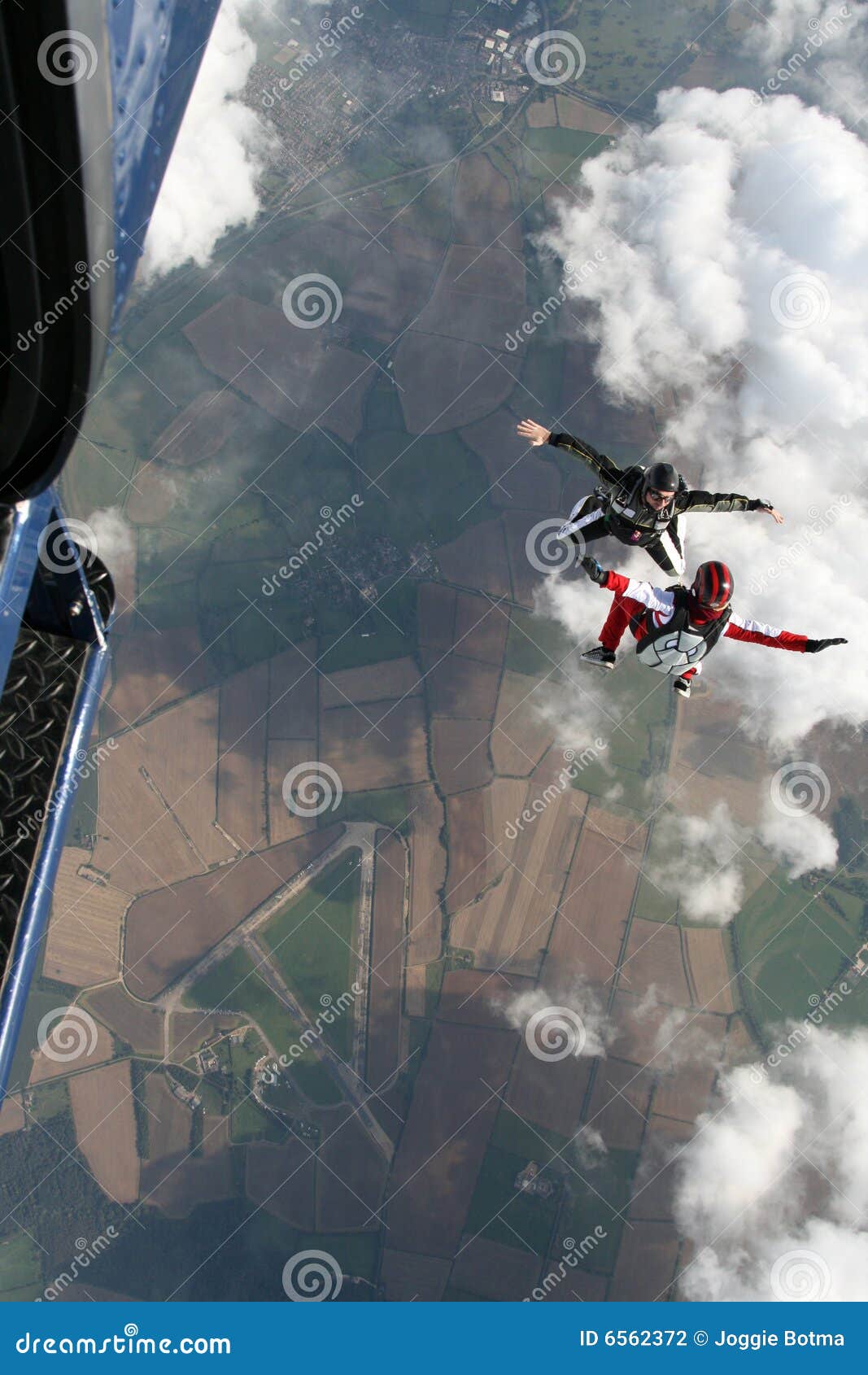 two skydivers exit a plane