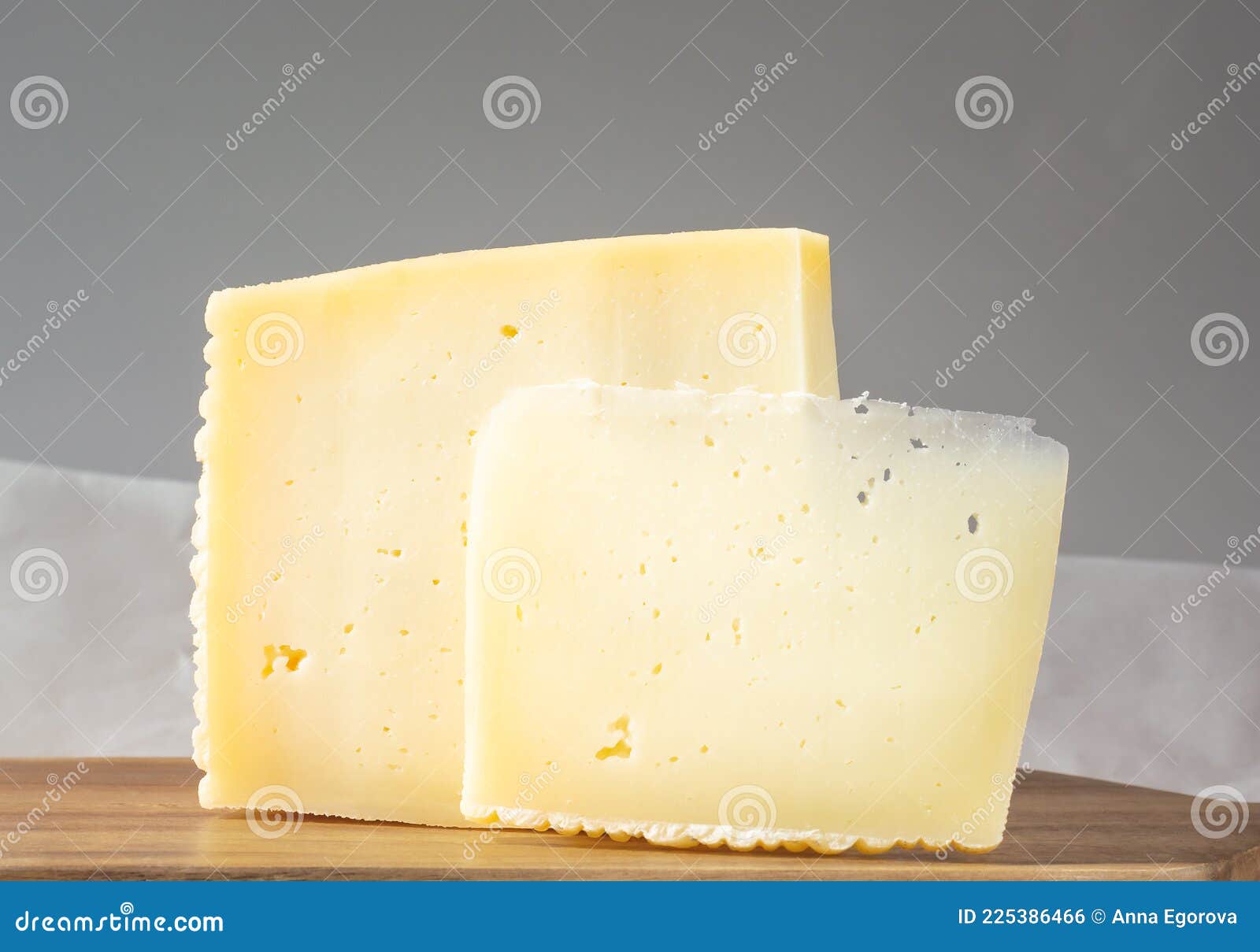 Two Slices of Asiago Cheese on a Gray Background Stock Photo Image of