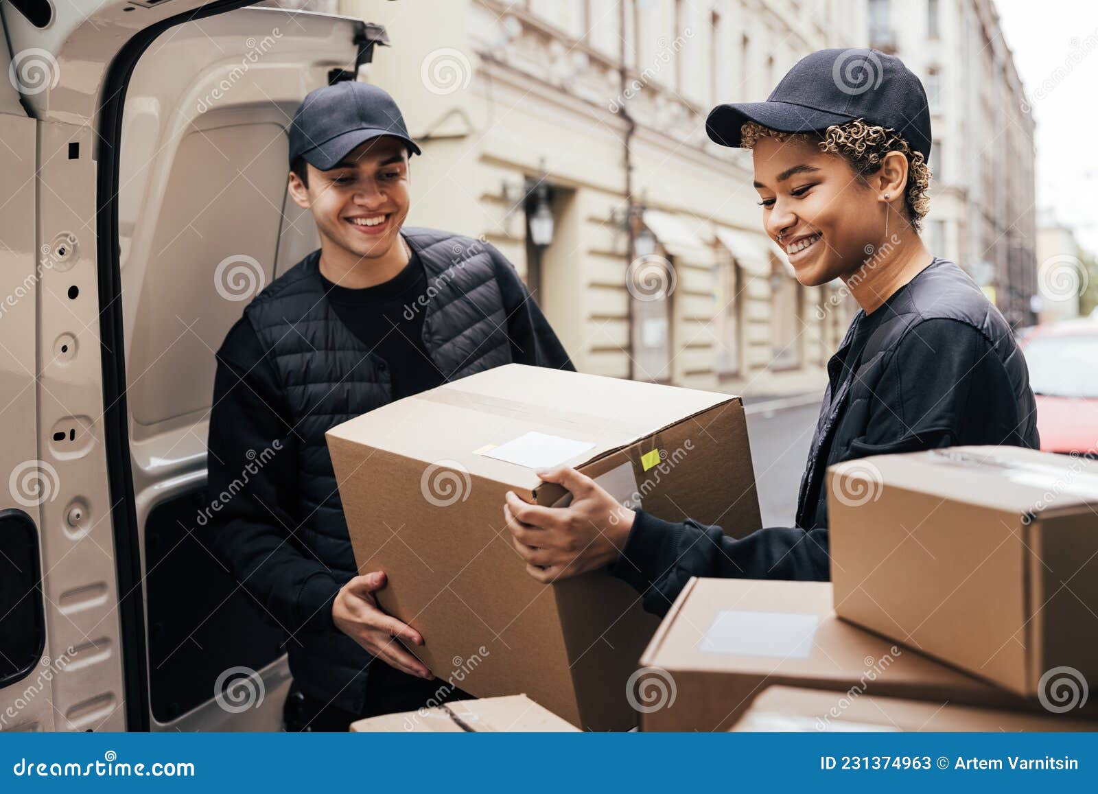 Smiling Couriers In Blue Uniforms And Young Women Filling Up Delivery