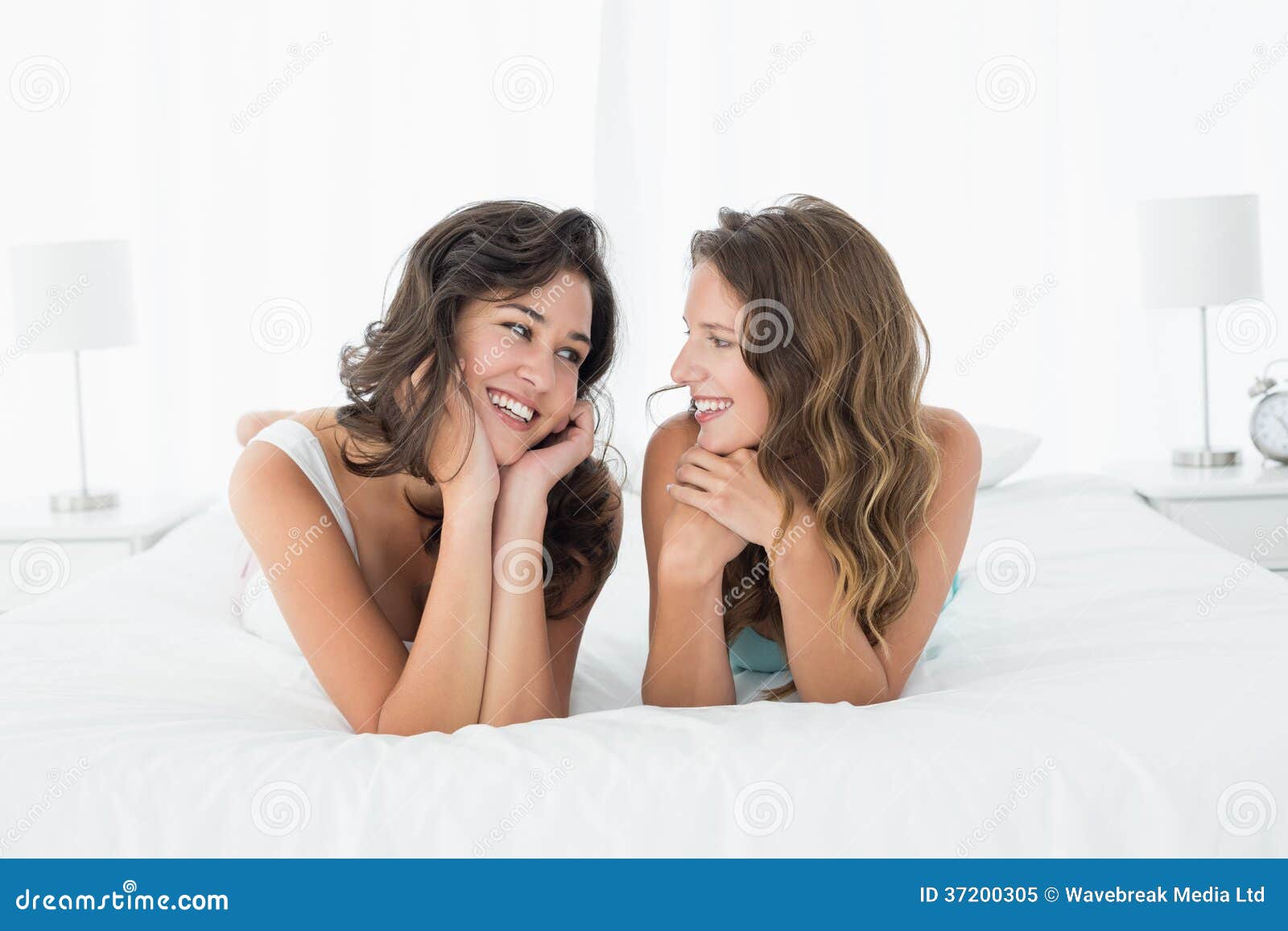 Two Smiling Female Friends Lying in Bed Stock Image Image of people