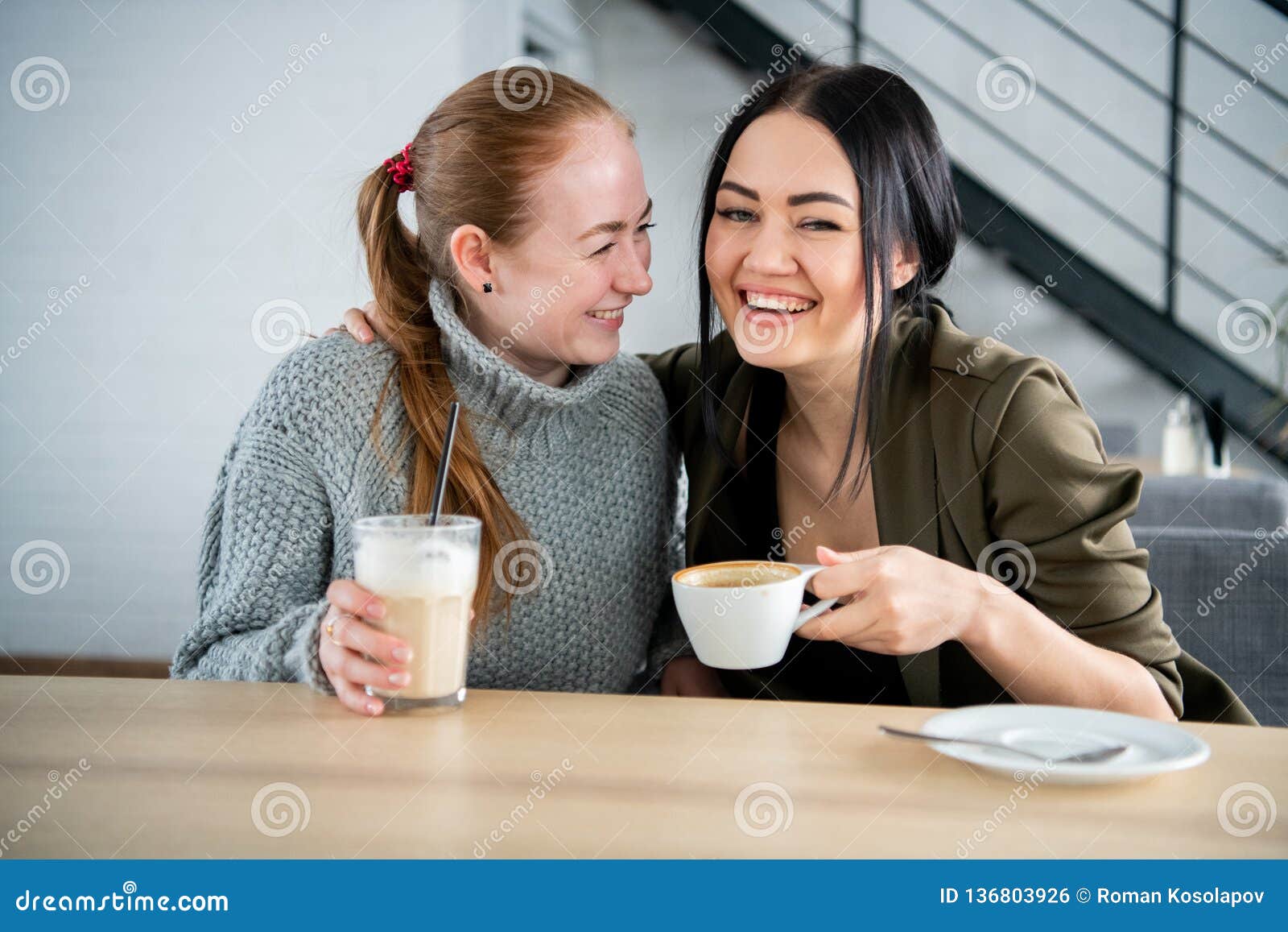 Two Smiling Students Having a Cup of Coffee in College Canteen Stock