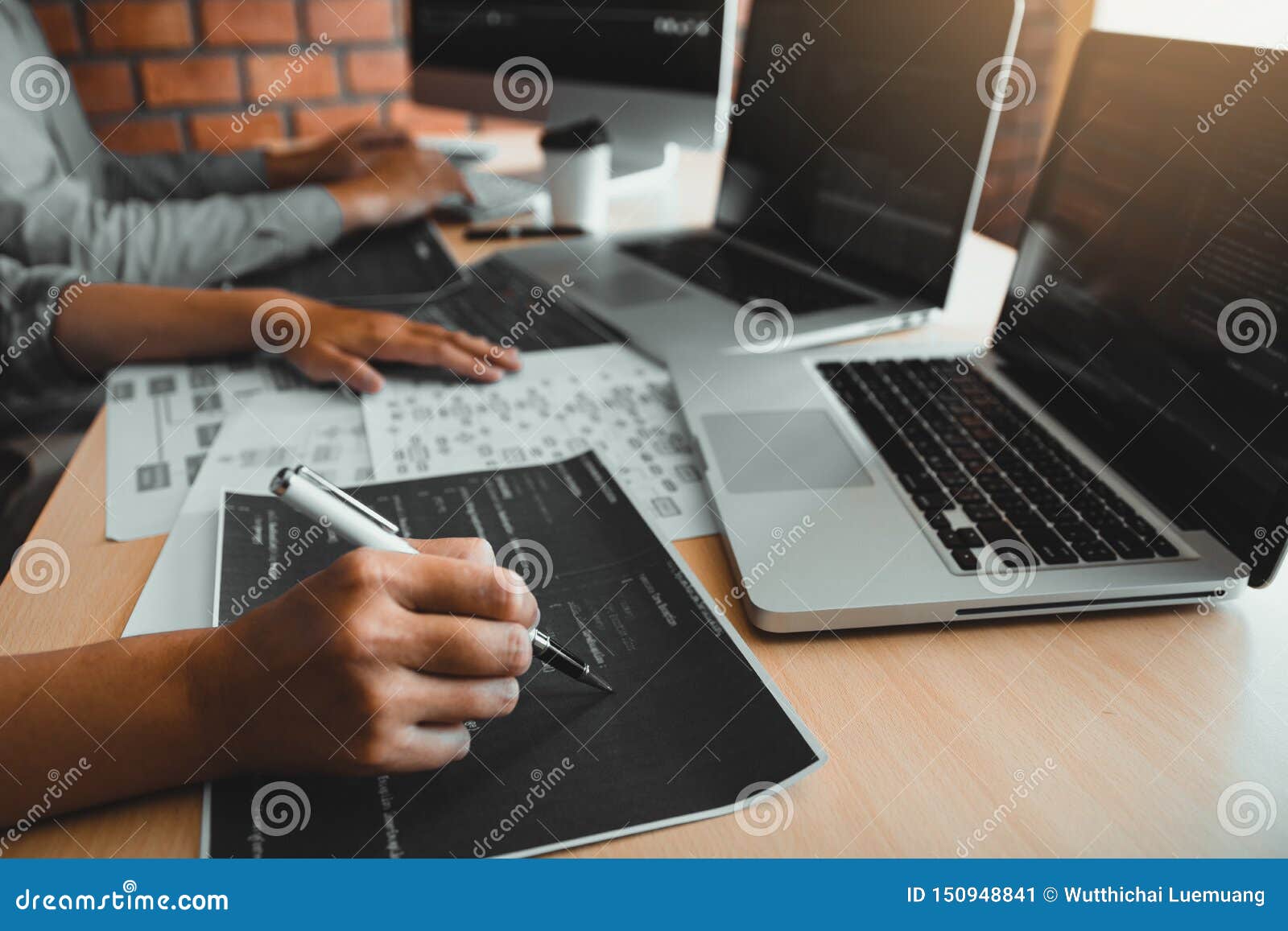 Two Software Developers Are Using Computers To Work Together With Their