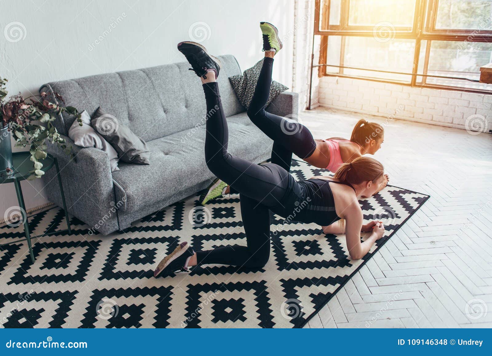 Two Sportive Female Friends Doing Toning Exercise Performing