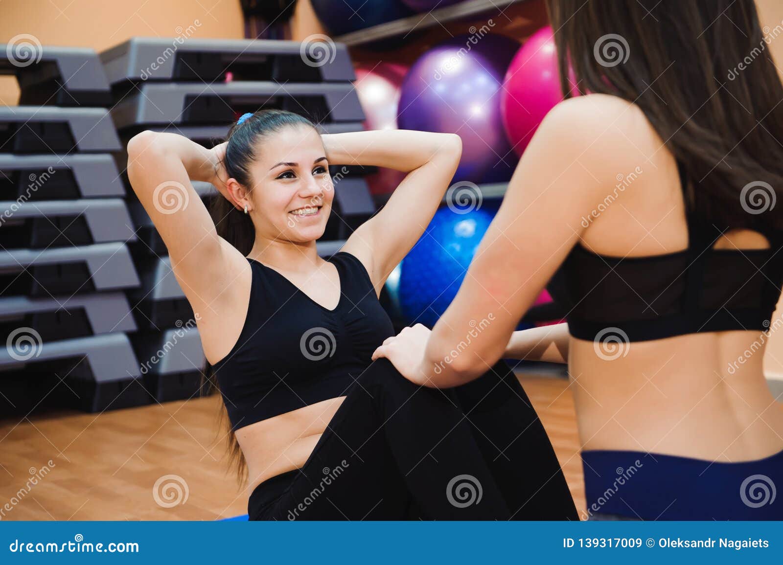 Two Sporty Women Doing Exercise Abdominal Crunches Stock Image