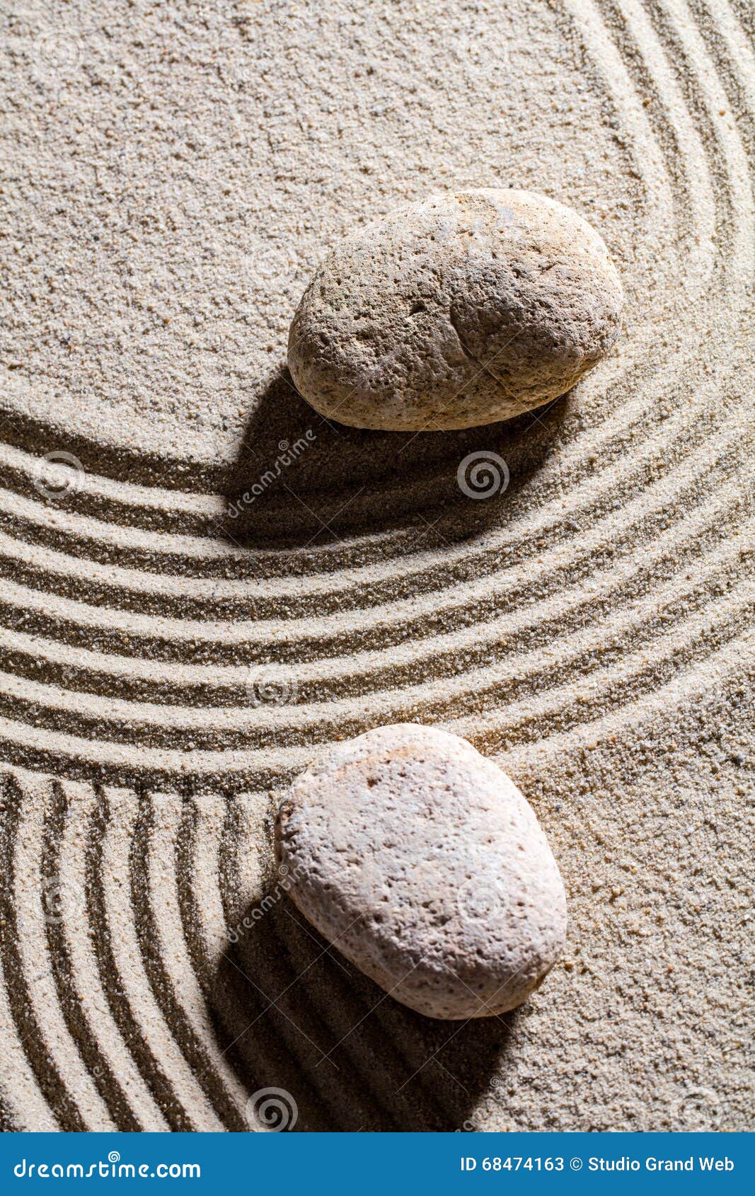 two stones across sand lines for concept of spirituality