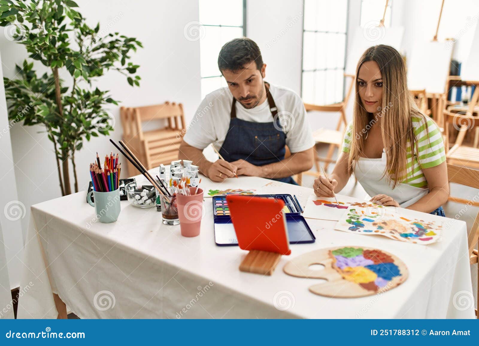 Two Students Having Online Paint Class Using Touchpad Sitting on the