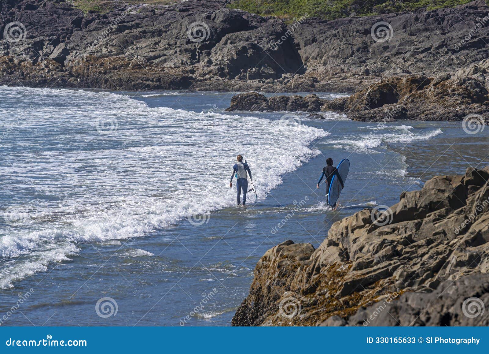 two surfers, tofino, vancouver island, canada